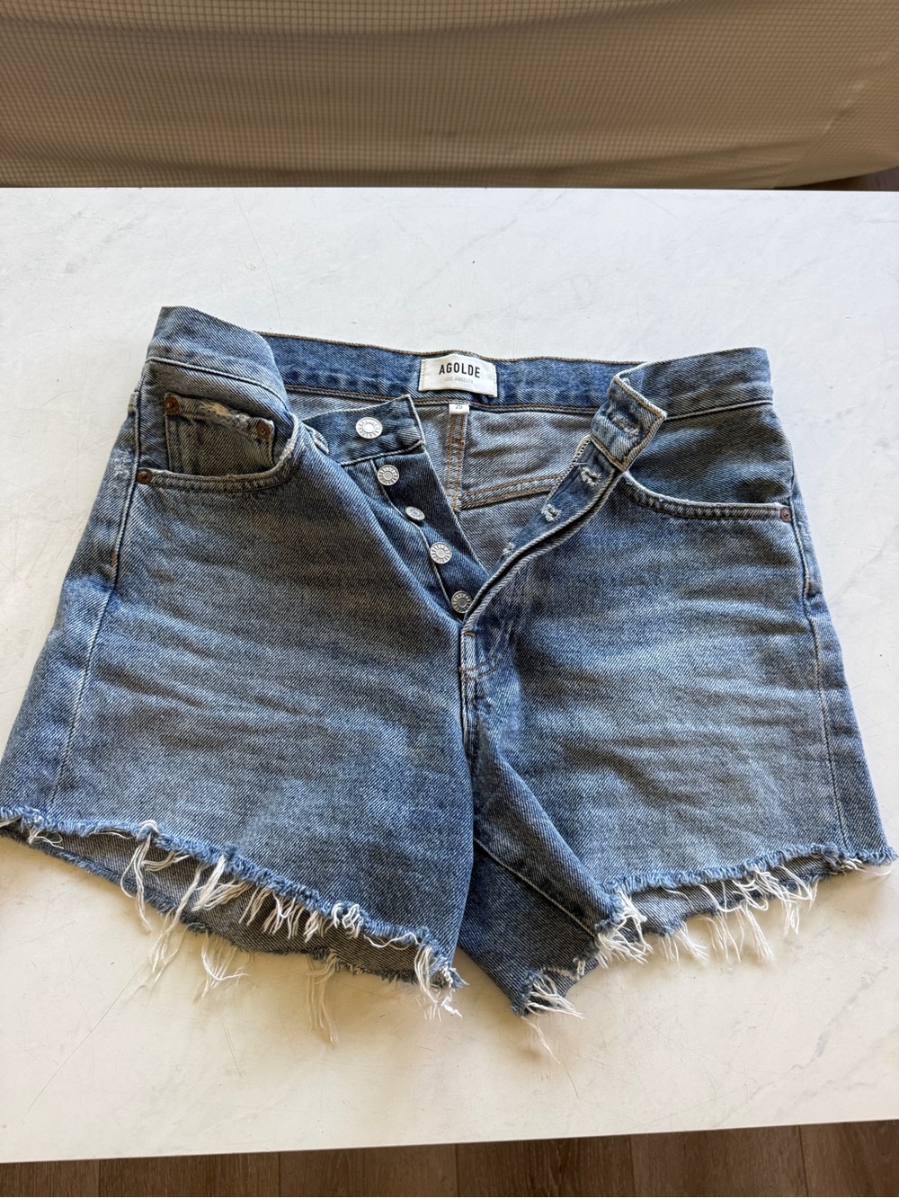 Agolde Distressed Medium Blue Denim Cutoff Shorts